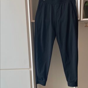 Uniqlo AlRism black joggers. Mesh inside pockets, back zip pkt. Elastic waist.